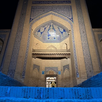 The façade of a mausoleum at night